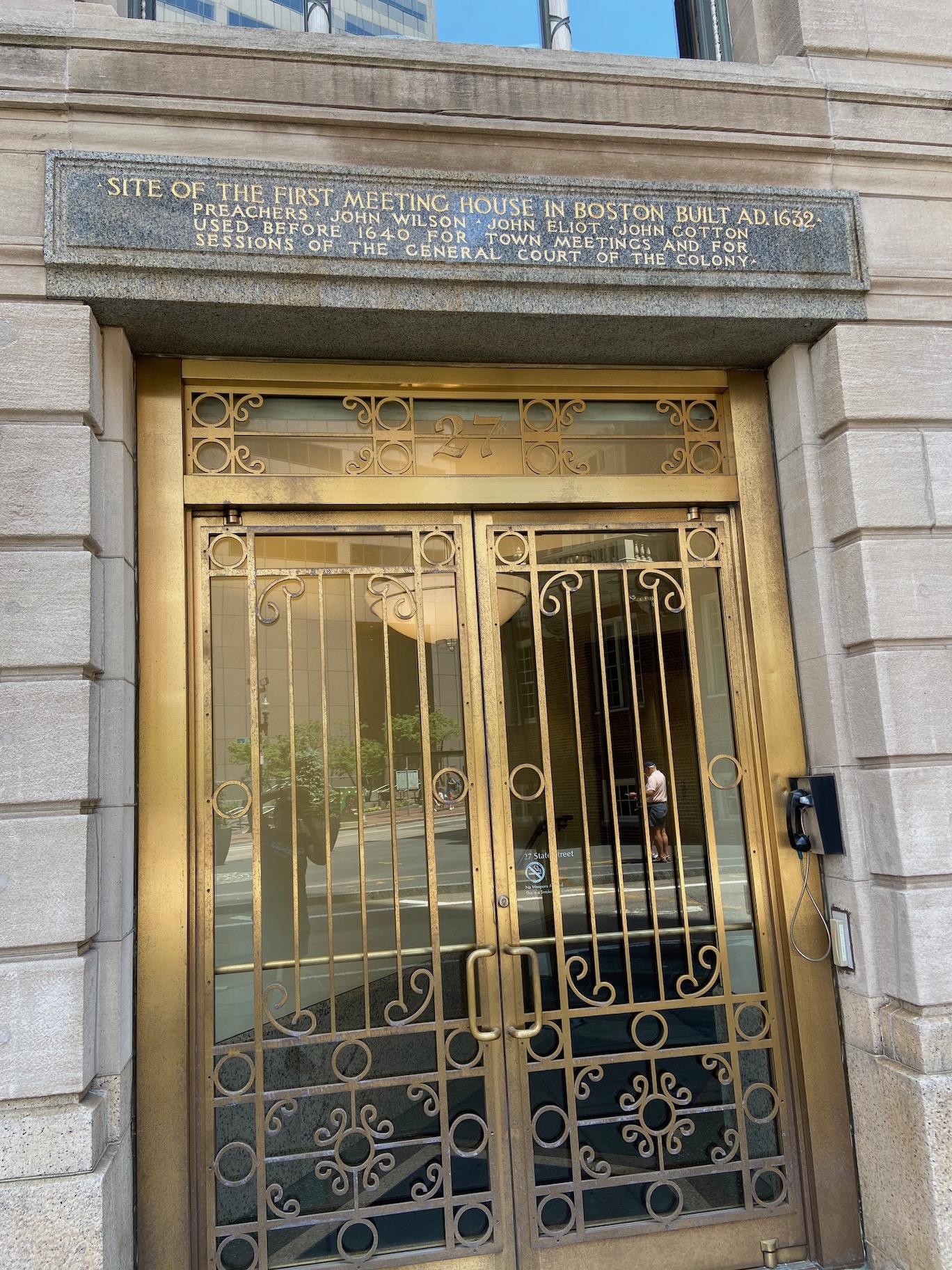 Image of a building in Boston with golden doors with sign that reads "SITE of the first meeting house in Boston Build AD 1632"