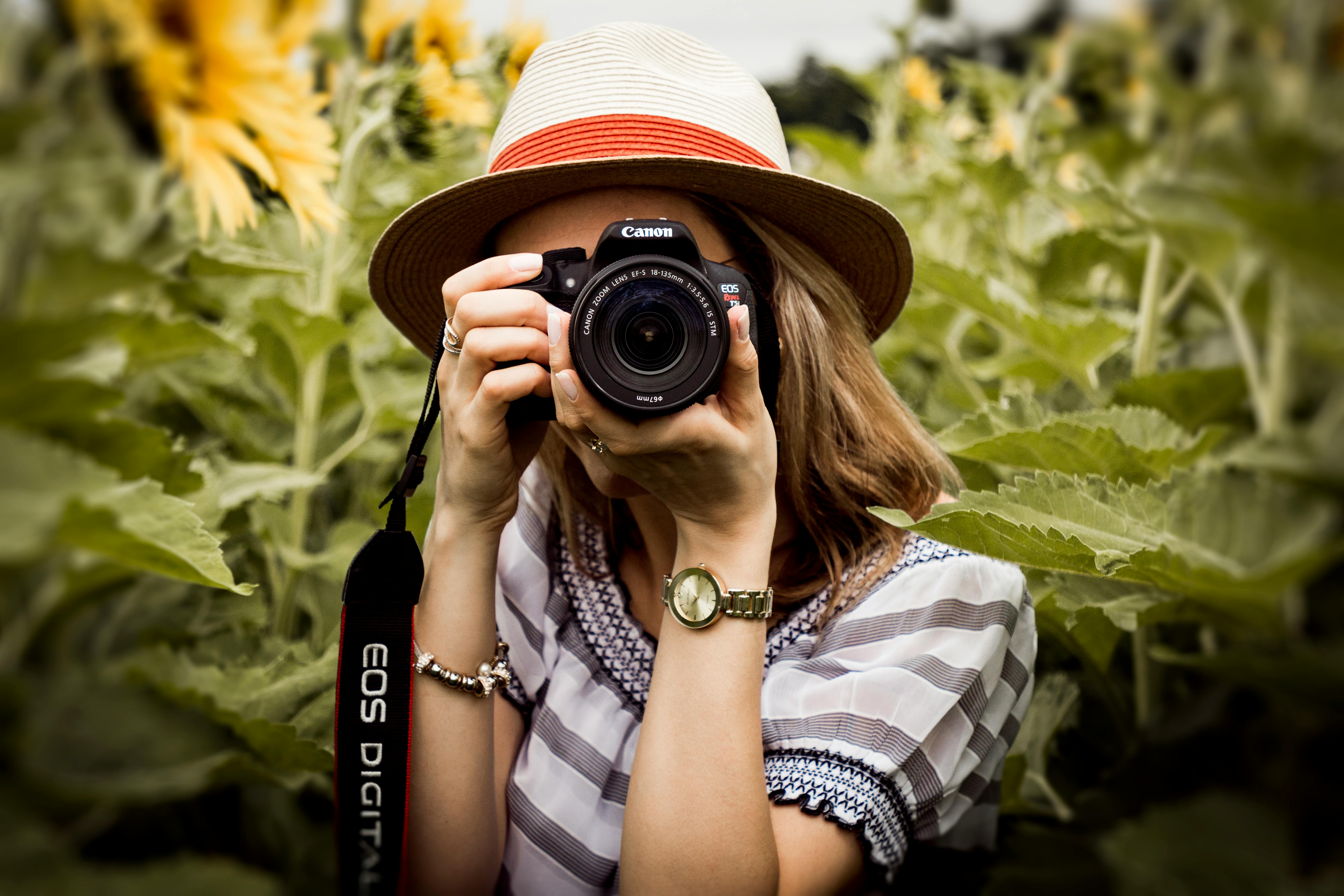 A woman is taking a picture. It looks like she is taking a photo of you.