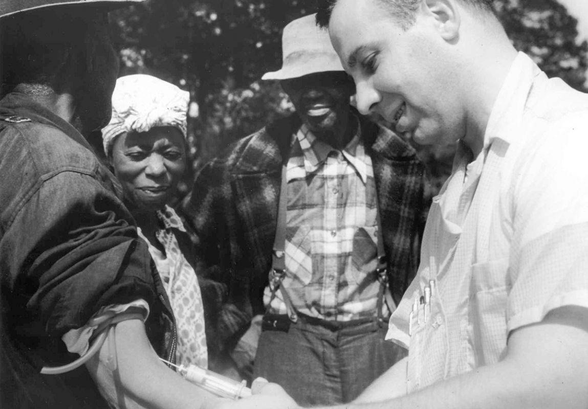 a doctor injects a Tuskegee syphilis study patient