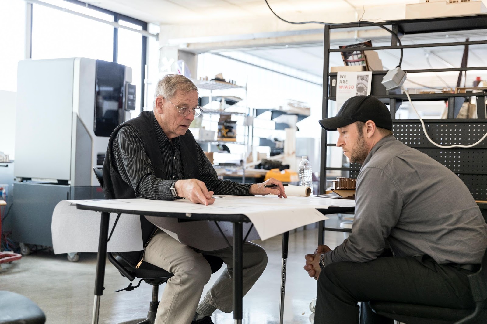 Photograph of an instructor sitting across from a student.