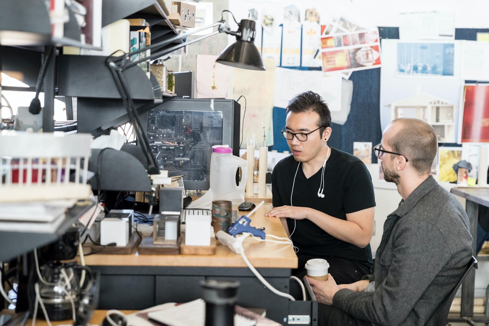 Photograph of two peers sitting together during a critique.