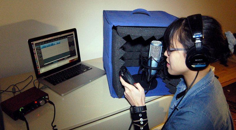 Image of woman recording at a comupter.