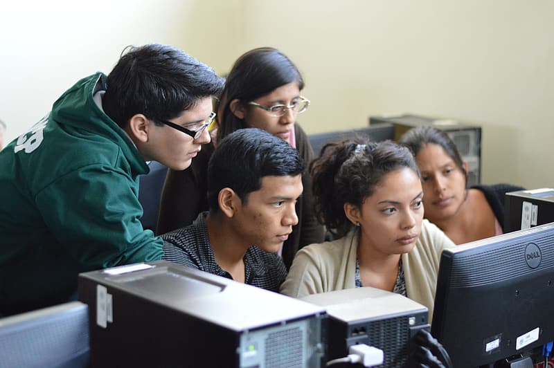 Students huddled around a comptuer