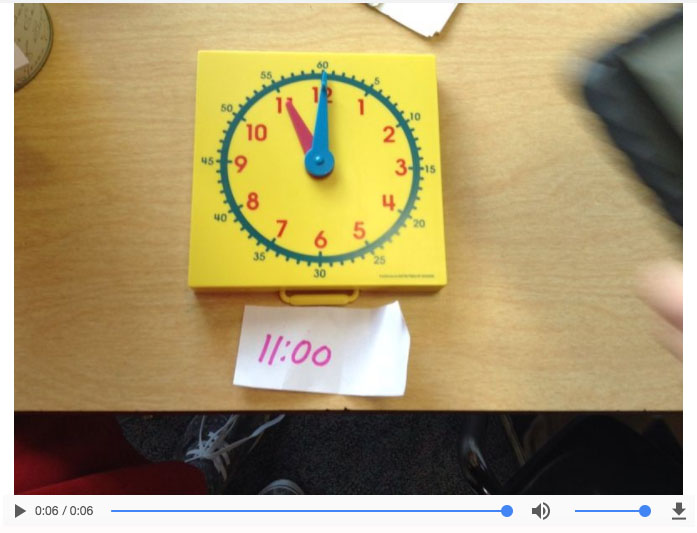 a plastic clock showing 11:00