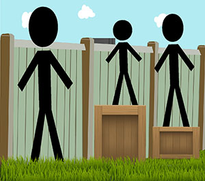 Three people of different heights standing in front of a fence. The two shorter people are standing on top of boxes in order to see over the top of the fence.