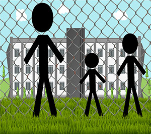 Three people of different heights standing in front of a chain link fence looking through at a building on the other side.