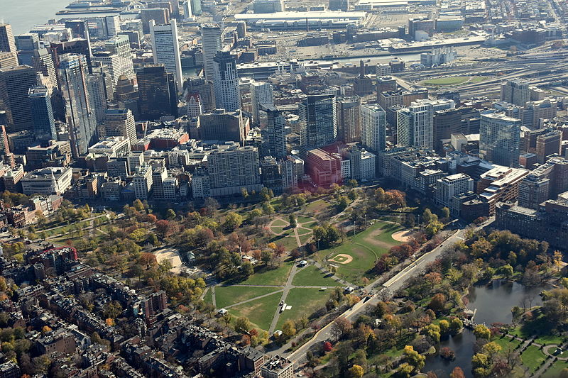 Aerial view of Boston Common from northeast. Includes portions of Beacon Hill (foreground left), Public Garden (foreground right) and Boston Financial District at Seaport (South Boston) at back.