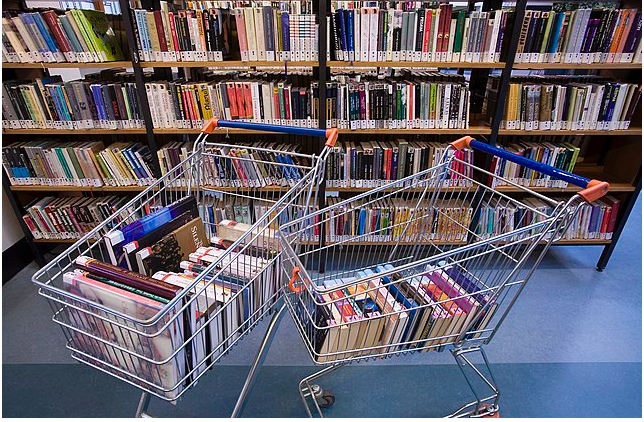 Books in shopping carts in a library