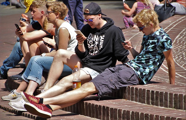 Boys looking at their smartphones