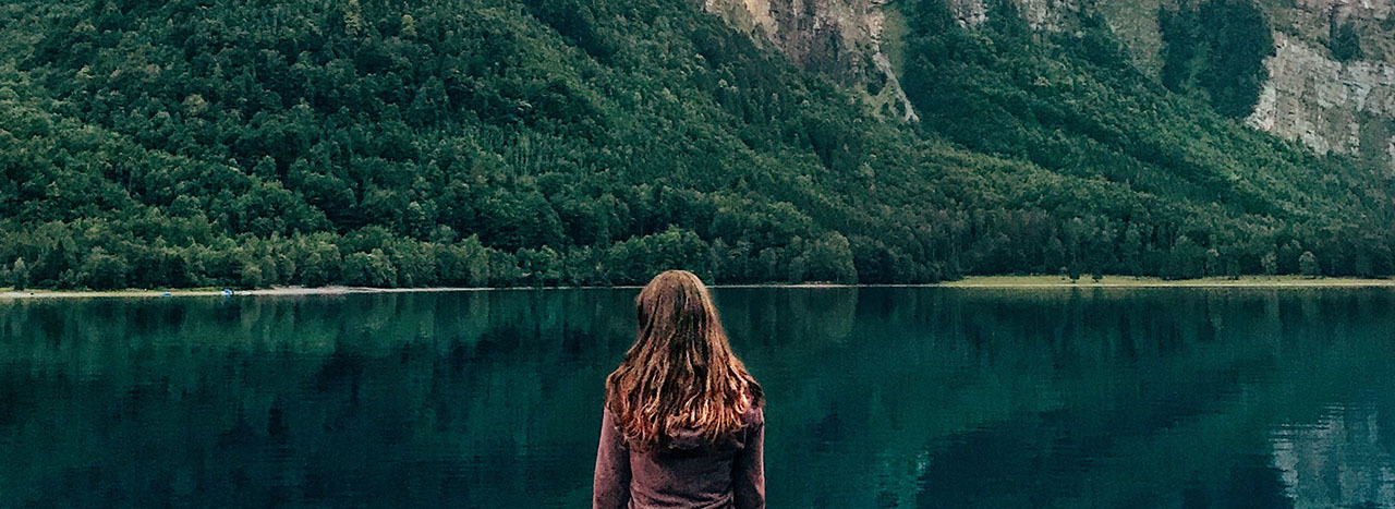 woman staring at a lake