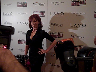 Marilu Henner standing in front of cameras.